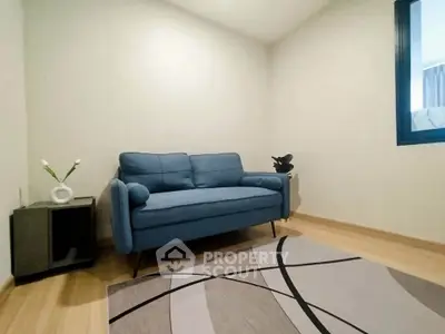 Cozy living room with modern blue sofa and stylish decor