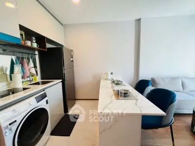 Modern open kitchen with sleek appliances and cozy living area