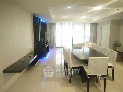 Spacious modern living room with elegant dining area and natural light