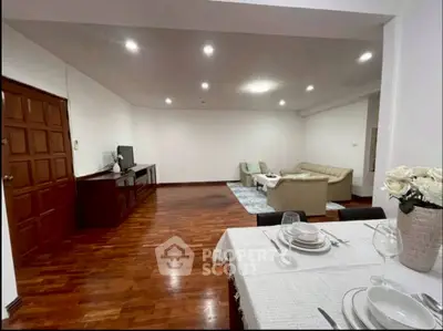 Spacious living room with elegant dining area and cozy seating, perfect for entertaining.