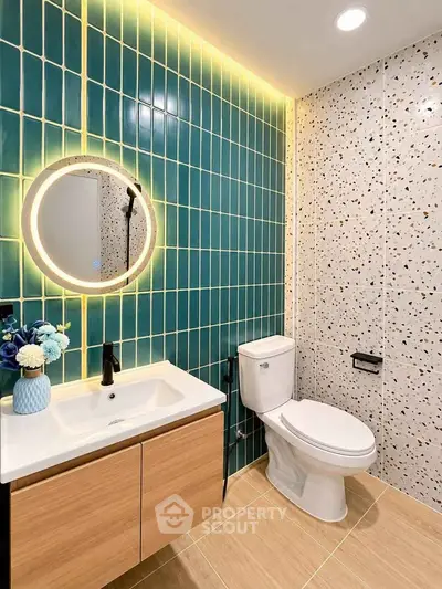 Modern bathroom with stylish tiles and illuminated mirror
