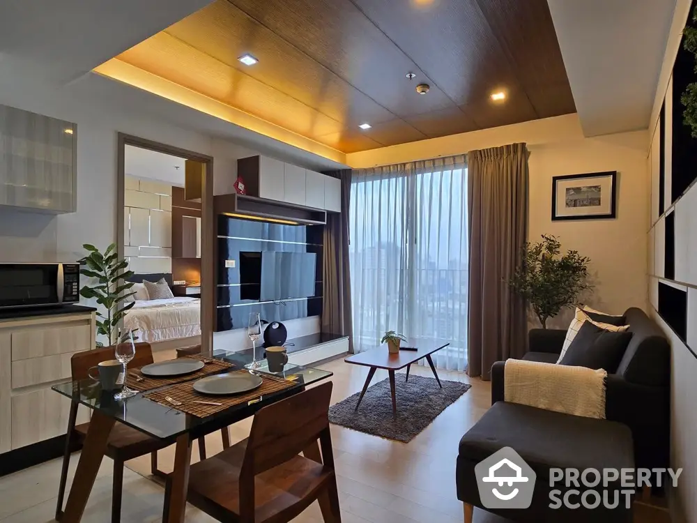 Modern open-plan living room with dining area and city view, featuring stylish furniture and natural light.