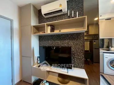 Modern living room with sleek TV setup and air conditioning unit