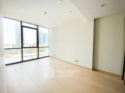 Spacious empty room with large windows and city view in modern apartment