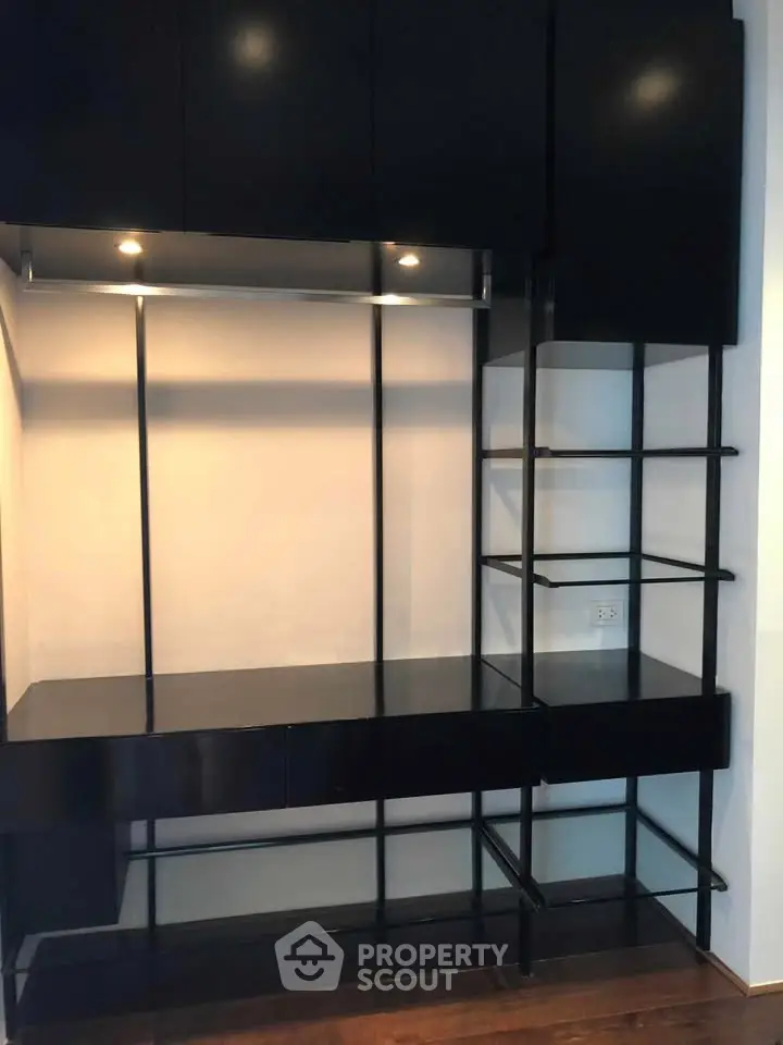 Modern black shelving unit with sleek design and integrated lighting, perfect for stylish storage solutions.