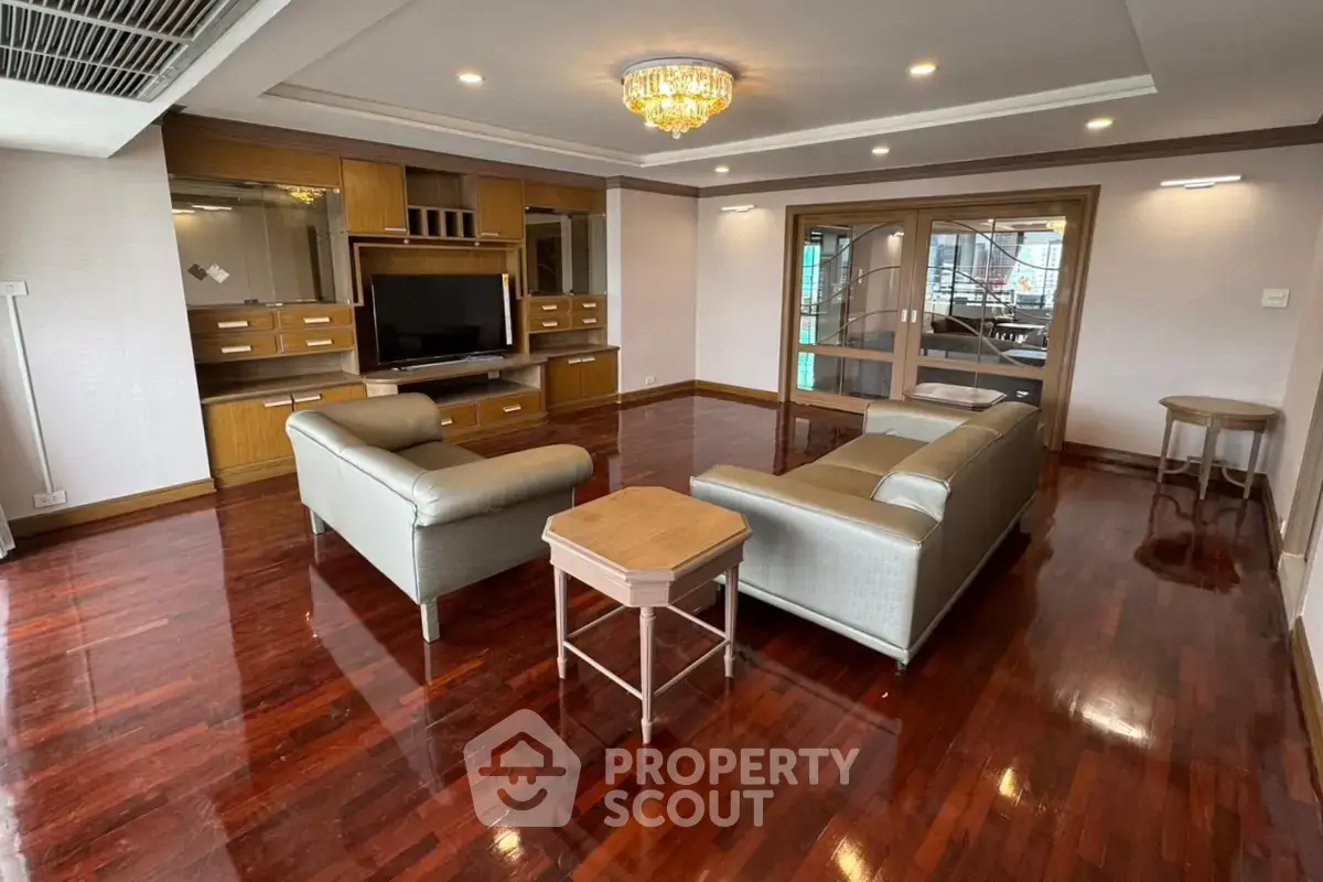 Spacious living room with elegant wooden flooring and modern furniture
