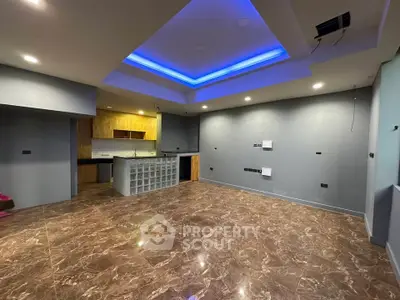 Spacious modern living room with marble flooring and ambient lighting