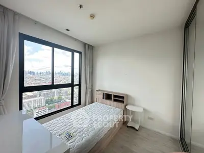 Modern bedroom with large window offering stunning cityscape view, minimalist design and ample natural light.