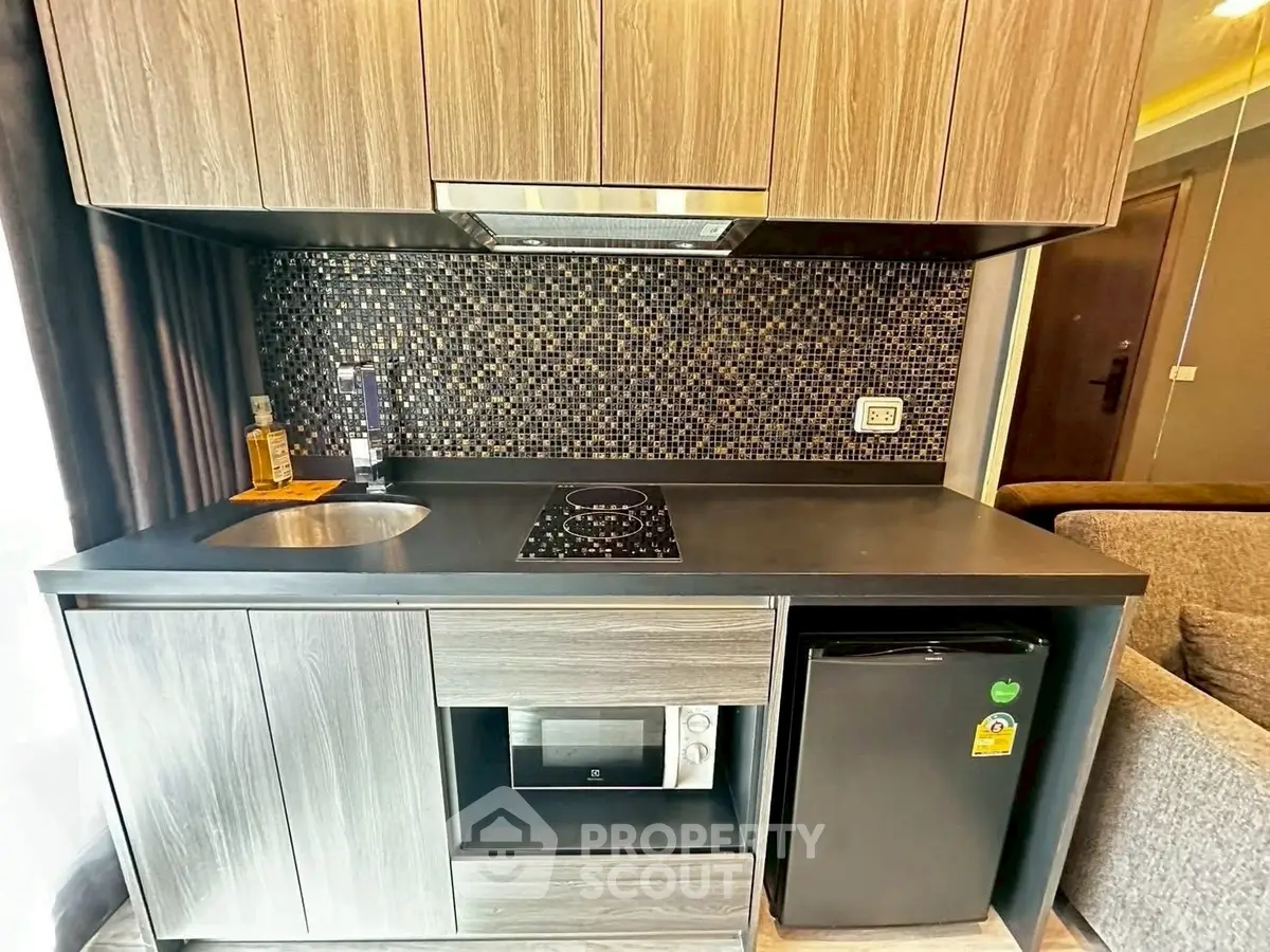 Modern compact kitchen with sleek cabinetry and built-in appliances