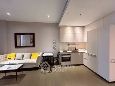 Modern open-plan living room with sleek kitchen and cozy seating area.