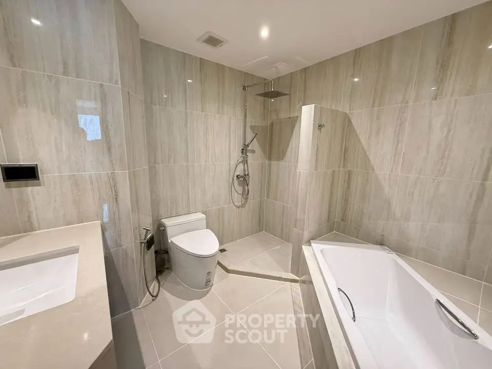 Luxurious modern bathroom with elegant tiling and spacious bathtub