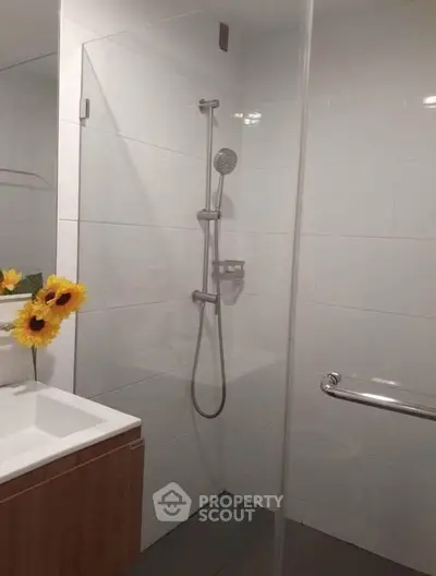 Modern bathroom with sleek shower and elegant fixtures, perfect for a contemporary home.