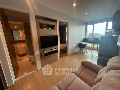 Modern apartment interior with cozy living room and dining area, featuring wooden flooring and natural light.