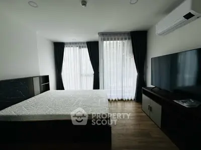 Modern bedroom with large windows and sleek furnishings