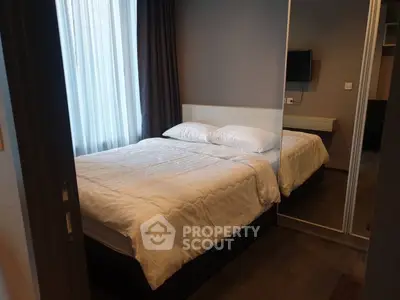 Cozy bedroom with modern decor and large mirror wardrobe