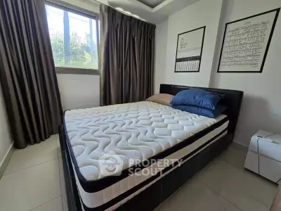 Cozy bedroom with modern decor and large window for natural light