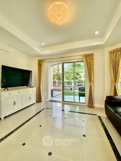 Spacious living room with elegant tile flooring and large window view