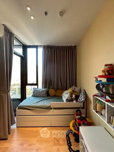 Cozy children's bedroom with modern decor and ample natural light.