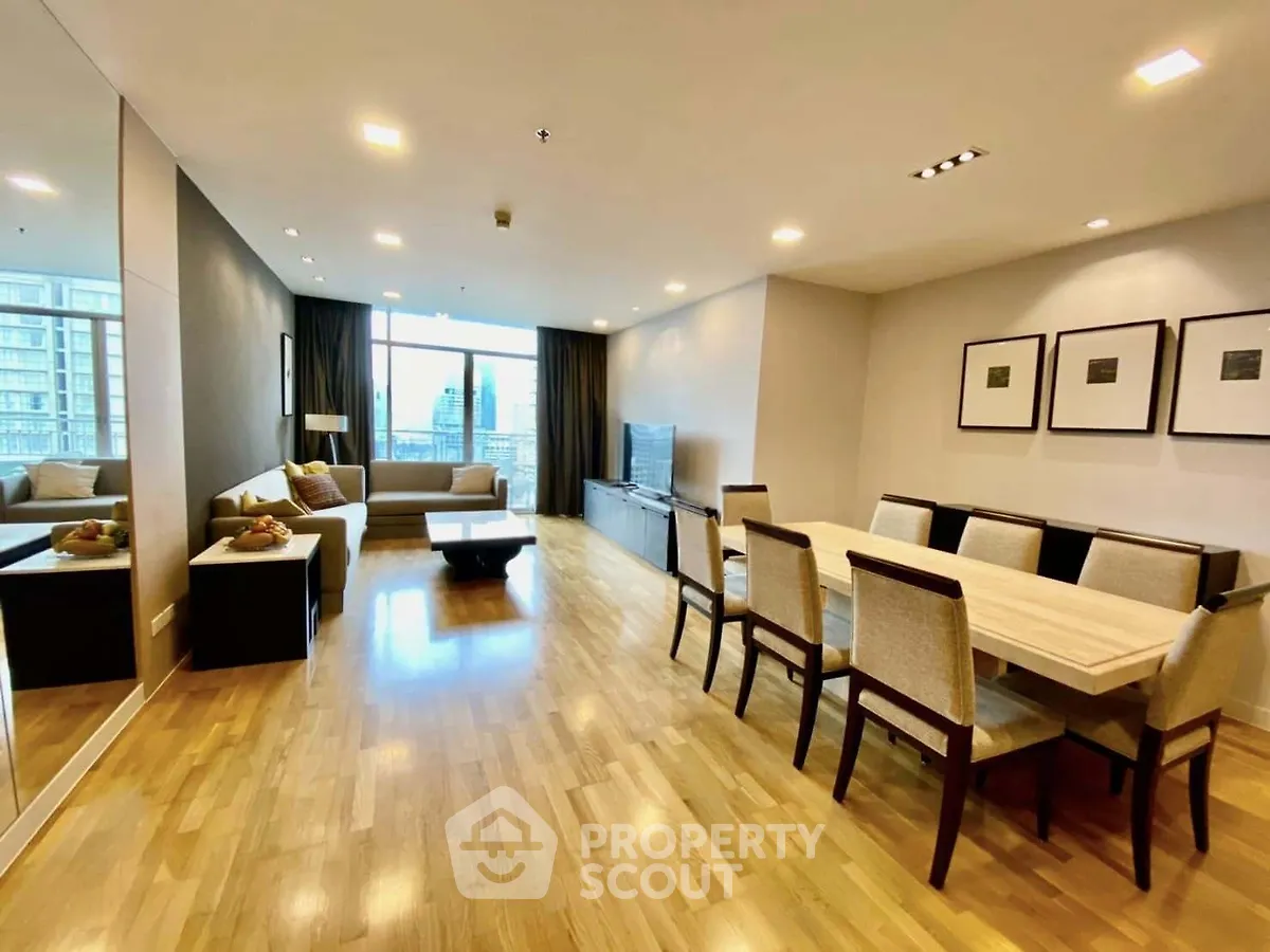 Spacious modern living room with dining area and city view