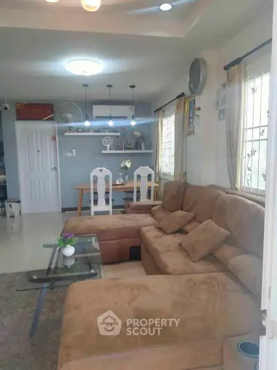 Spacious living room with cozy sectional sofa and modern decor, perfect for relaxation and entertaining.