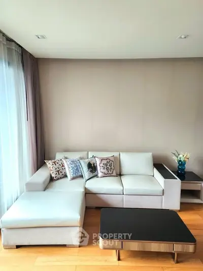 Modern living room with stylish sofa and coffee table, perfect for relaxation.