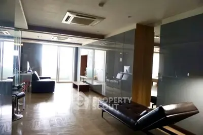 Spacious modern living room with sleek furniture and large windows for natural light.