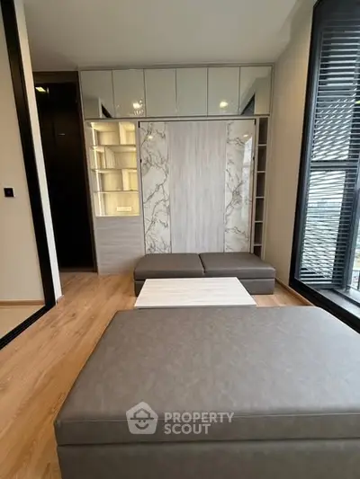 Modern living room with stylish furniture and large windows offering natural light.