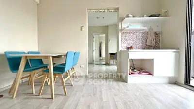 Modern dining area with open kitchen and stylish blue chairs