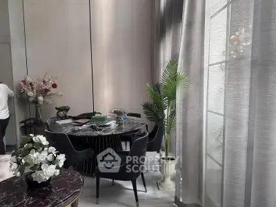 Elegant dining area with modern decor and large windows
