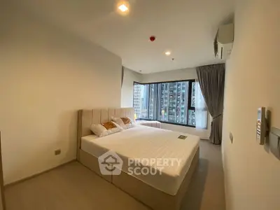 Spacious modern bedroom with large windows and city view