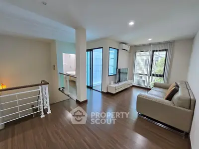 Spacious modern living room with sleek wooden flooring and natural light