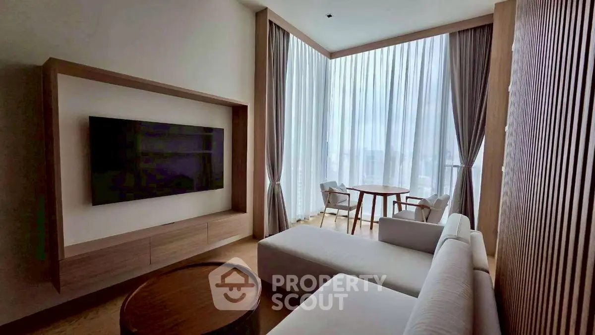 Luxurious living room with floor-to-ceiling windows and modern furniture.