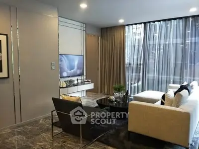 Elegant modern living room with floor-to-ceiling windows and stylish furniture.
