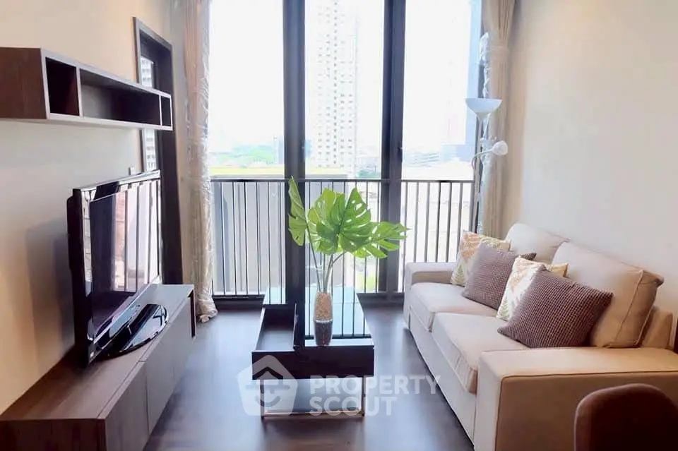 Modern living room with large windows and stylish decor in a high-rise apartment.