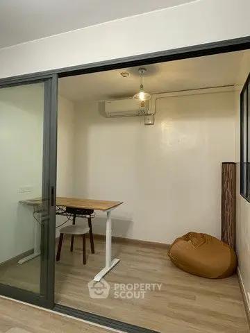 Modern study room with glass sliding doors and minimalist furniture