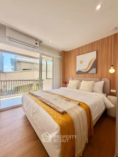Modern bedroom with large window and stylish decor