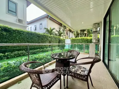 Spacious balcony with elegant outdoor seating and lush garden view
