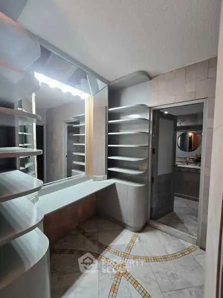 Spacious bathroom with modern shelving and large mirror