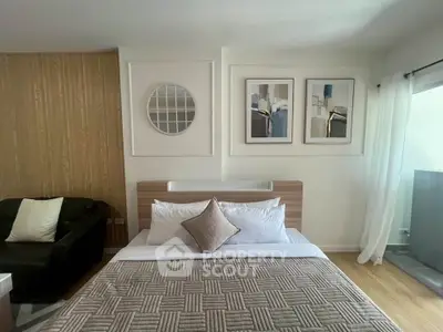 Modern bedroom with stylish decor and large window for natural light