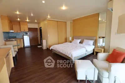 Spacious studio apartment with modern kitchen and cozy living area, perfect for urban living.