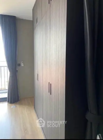 Modern bedroom with large wardrobe and balcony access