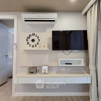 Modern living room with wall-mounted TV, air conditioner, and stylish clock on a sleek shelf.