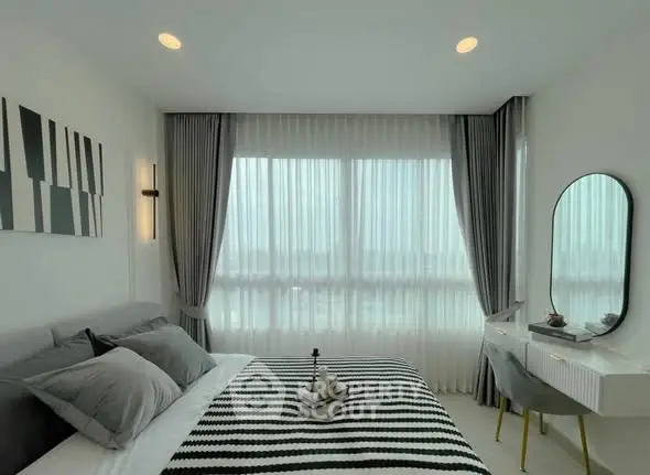 Modern bedroom with stylish decor, large window, and elegant curtains in a bright apartment.