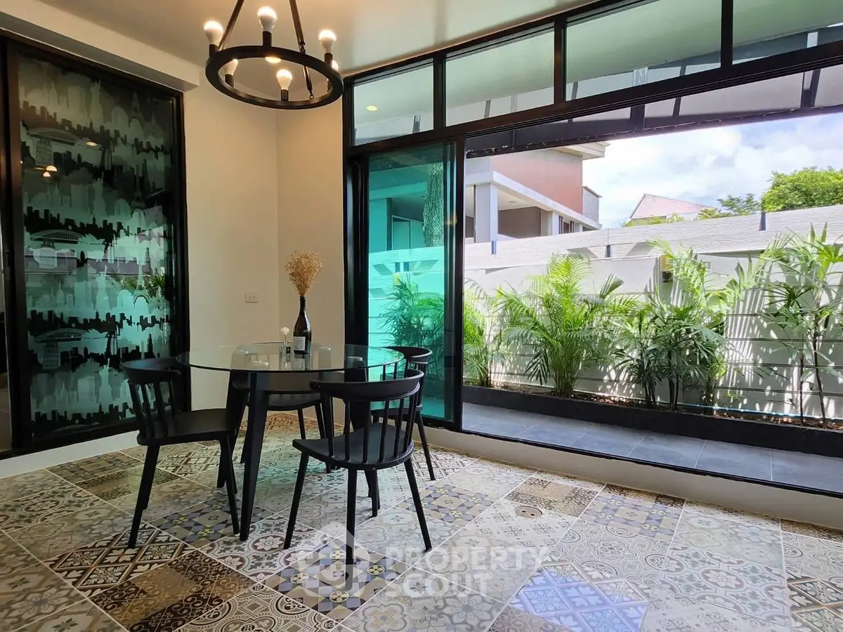 Chic dining area with glass doors opening to lush garden view