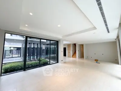 Spacious modern living room with large windows and garden view