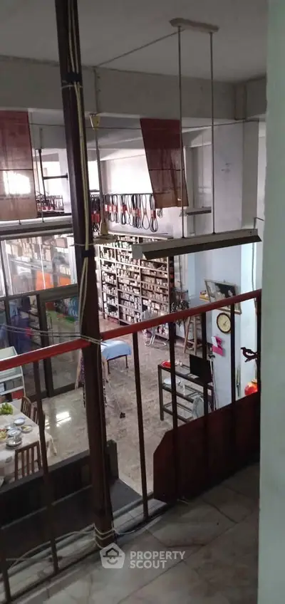 Spacious multi-level interior with dining area and extensive shelving, ideal for retail or office use.