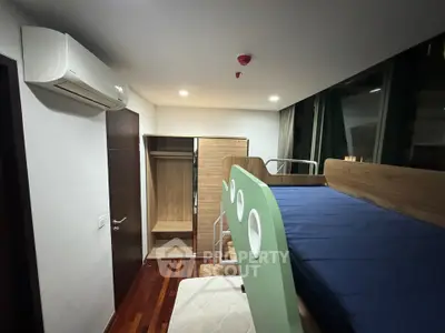 Modern bedroom with bunk bed and air conditioning in stylish apartment