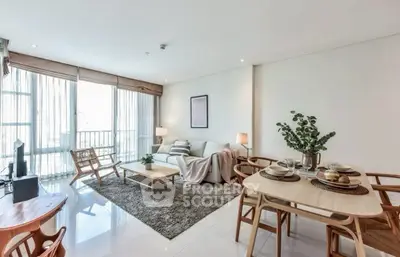 Spacious modern living room with elegant dining area and natural light