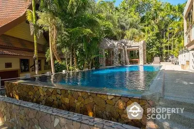 Luxurious tropical poolside retreat with lush greenery and serene ambiance.