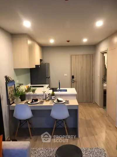 Modern kitchen with open layout and stylish dining area in a cozy apartment.